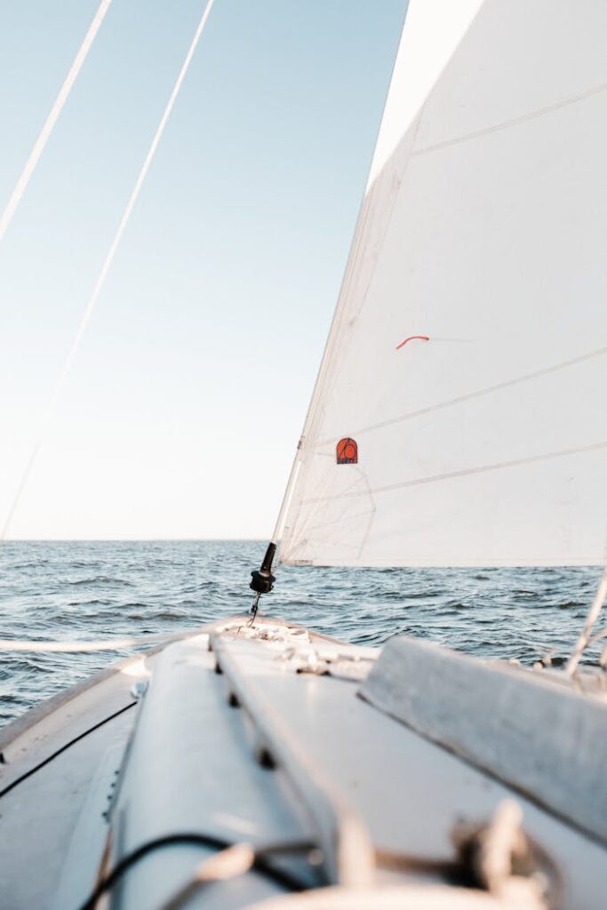 Tranquil view from a sailboat on open water in Norfolk, VA, under clear skies.